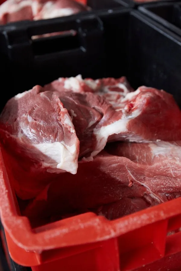 Fresh cuts of French pork in a crate before mixing.